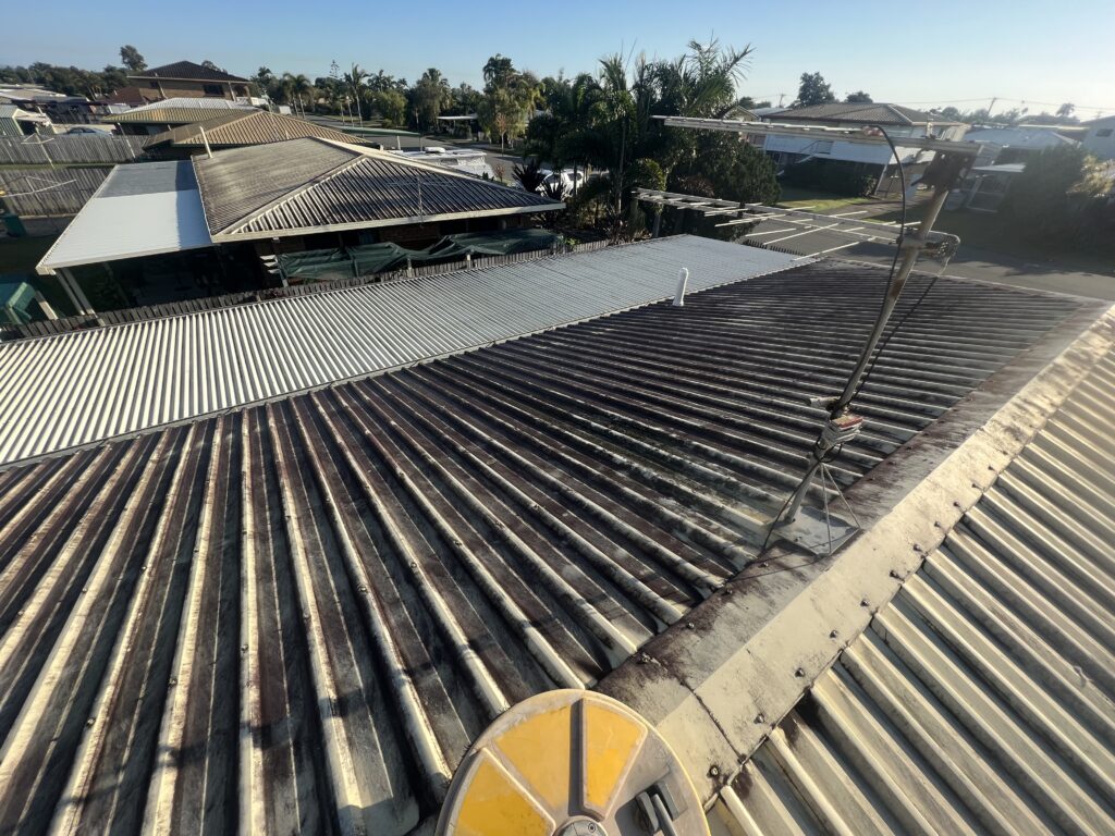 Mould and algae build-up on a Colorbond roof in South Mackay before cleaning