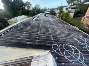 Professional roof cleaning Bucasia transforming a stained Colorbond roof