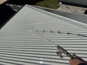 Roof being cleaned with pressure gun