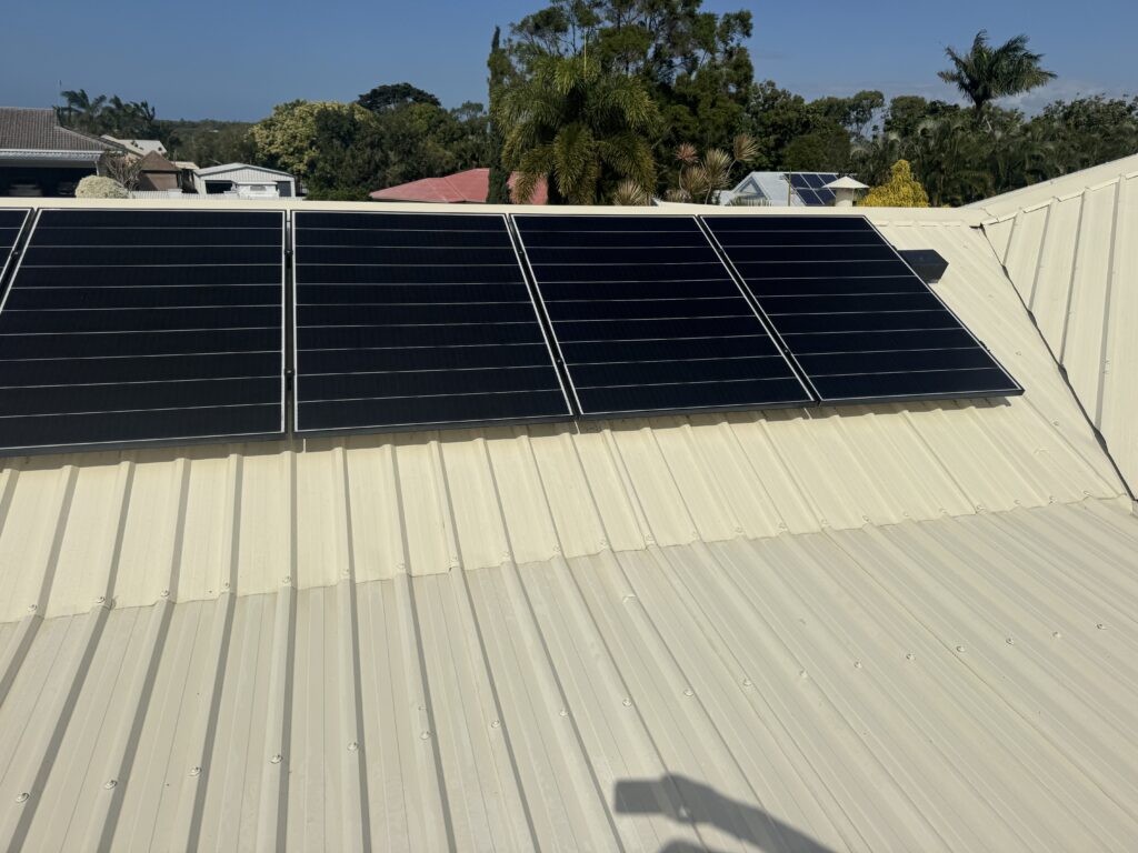 Clean cream-coloured roof sheets and solar panels on the Eimeo property.