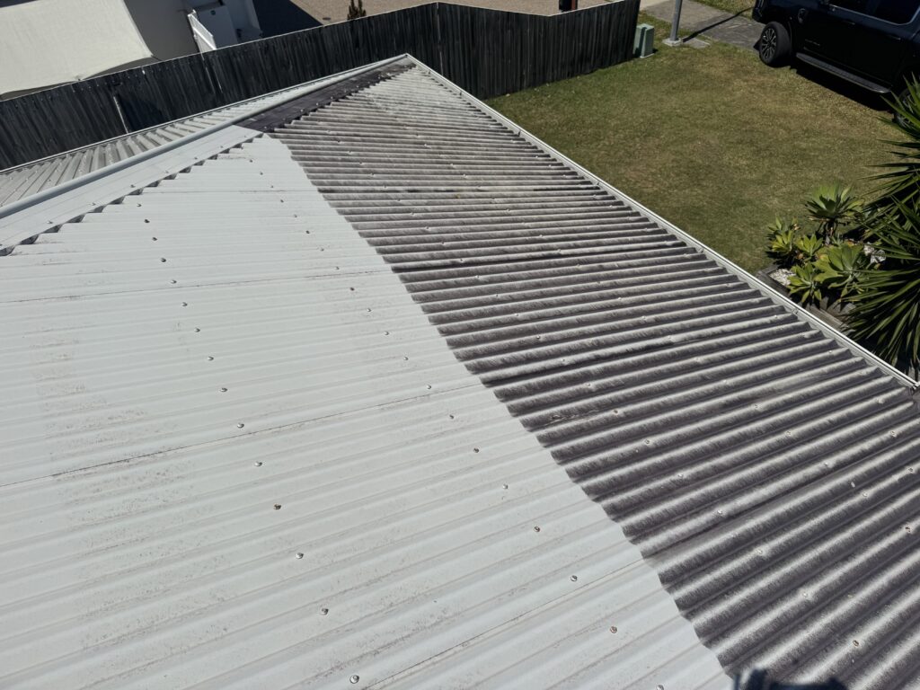 Half-cleaned corrugated metal roof showing mould removal during a Bakers Creek roof clean