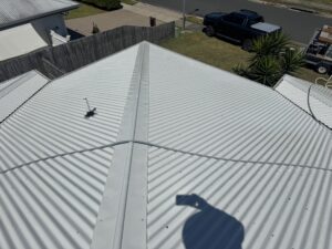 Low-pressure roof cleaning in progress on a light-coloured Bakers Creek roof