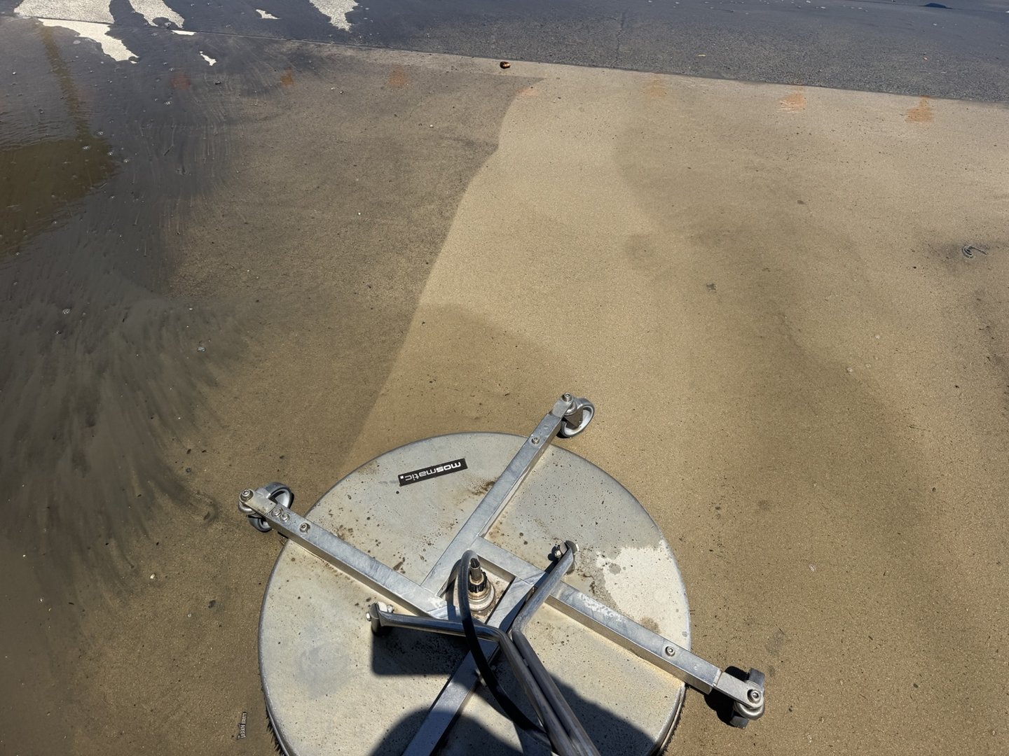 Rotary surface cleaner pressure cleaning wet concrete at CQ Rescue in Mackay