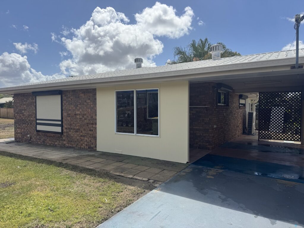 Sarina house washing result showing the brick exterior, cream wall and gutter line
