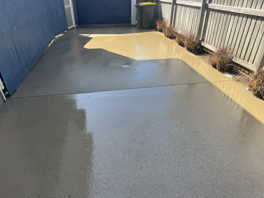 Concrete driveway beside the shed after pressure cleaning in Slade Point