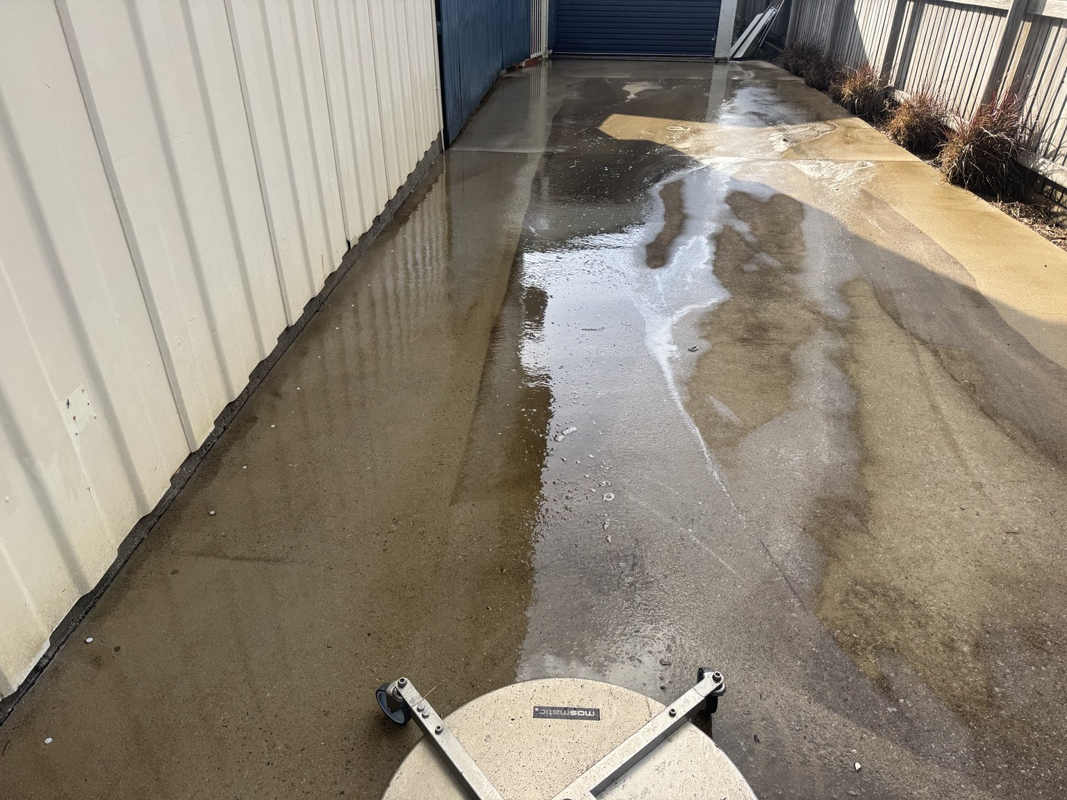 Surface cleaner working across the driveway during pressure cleaning in Slade Point